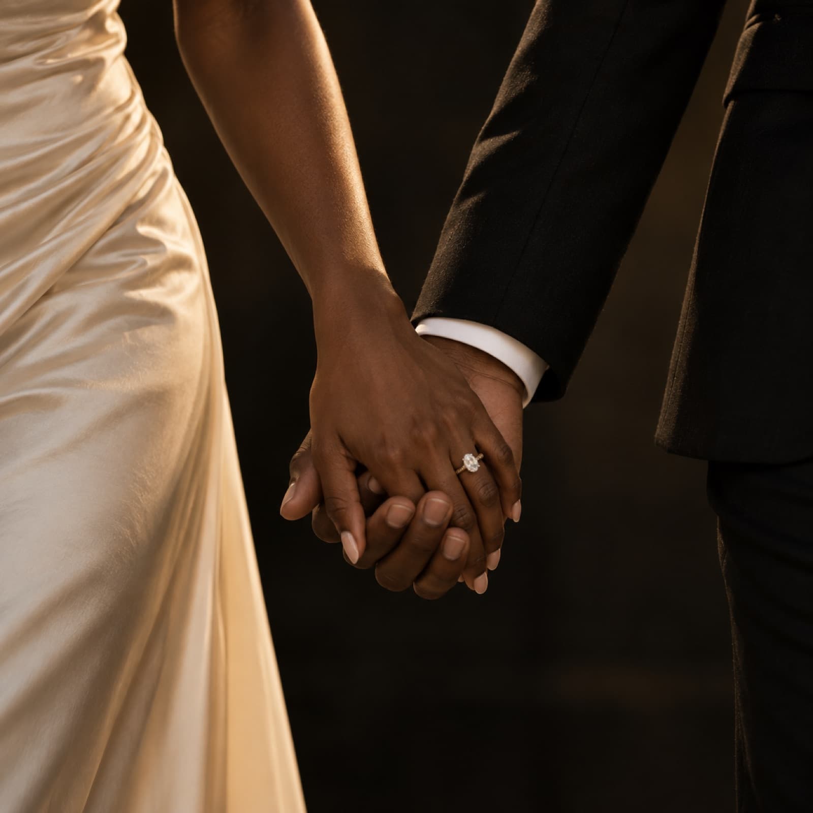 A tender detail of the couple's clasped hands